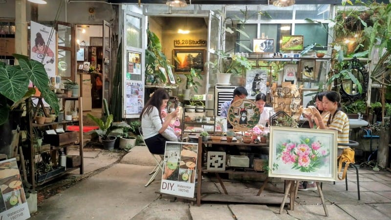 Visitors painting and crafting at Baan Kang Wat